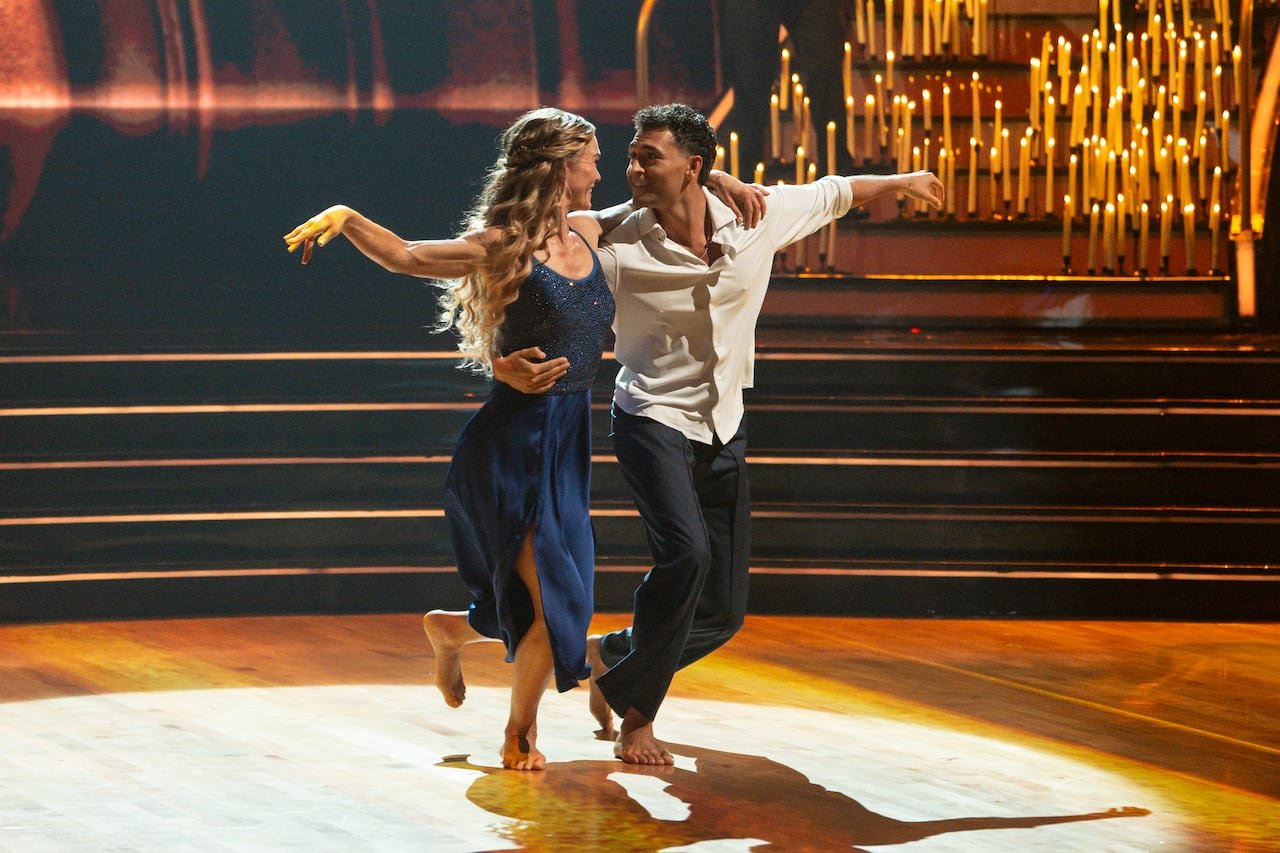 man and woman dance surrounded by candles